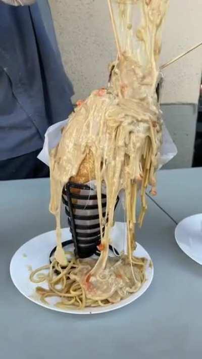 French bread stuffed with chicken broth pasta, a cornish game hen, and cheesy cream sauce