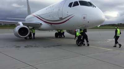 The airport did not have the right equipment for this Russian Sukhoi 100 for pushback. The pilot was very happy for this unusual service form the Norwegian ground crew.