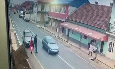 Today in Romania, Illegally parked couple get hit by their own car, after it's hit by a vehicle carrying even more vehicles. (They were taken to hospital but are OK)