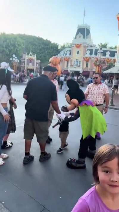 Mickey Mouse scolds a parent at Disneyland for being on their phone and not watching their kid after the child ran into him and fell down