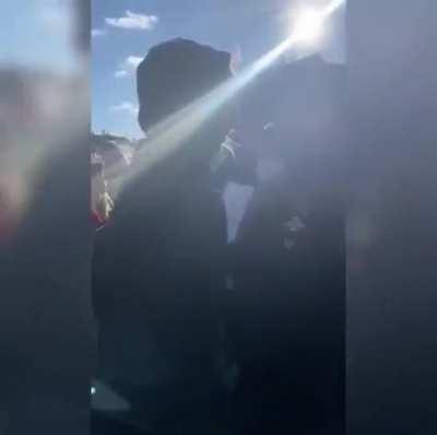 Woman with a blank sheet of paper gets detained.