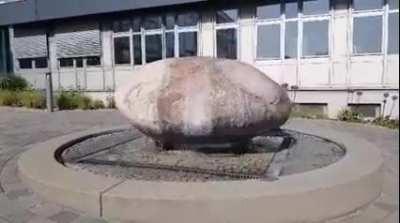 A Massive Boulder Getting Pushed Around On Top Of A Fountain