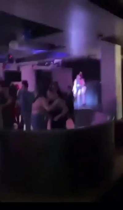 Women dancing on stage in American flag themed lingerie at the TPUSA afterparty attended by Matt Gaetz. TPUSA has now removed their ambassador that threw the party.