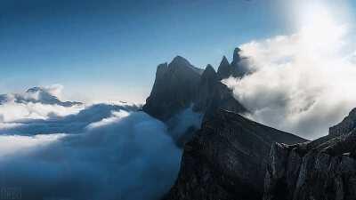 Air currents being disrupted by mountain-tops making clouds appear as breaking ocean waves.