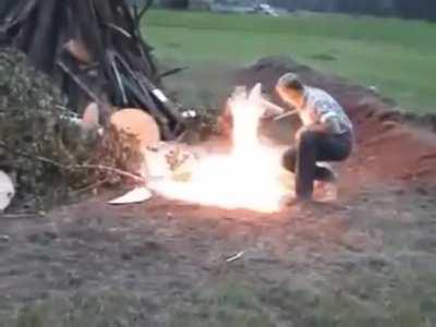 Pouring a container of gas and trying to light a bon fire