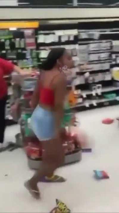 Lady restocks shelves in a Walgreens while moonwalking the whole time