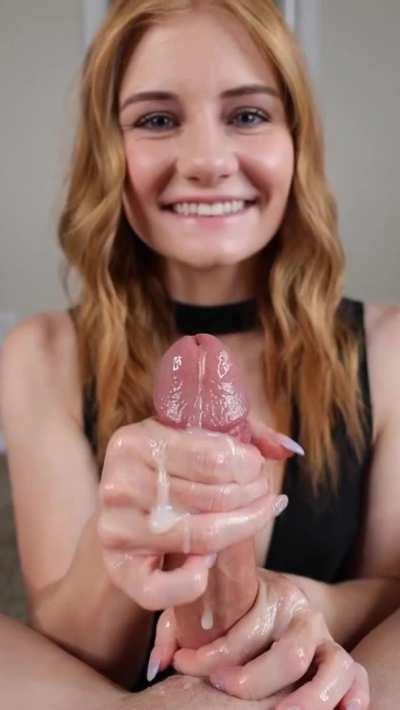 Cute Redhead smiling while she strokes him