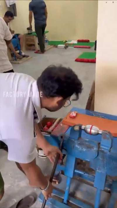International test cricket match ball making inside a factory.