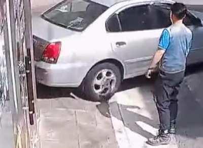 A passing woman jumps in to help a man whose runaway car was stuck in reverse