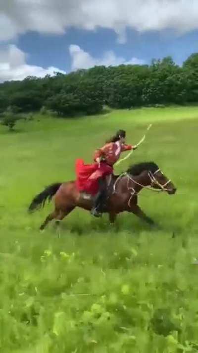 Archer shooting 3 targets, while riding a horse