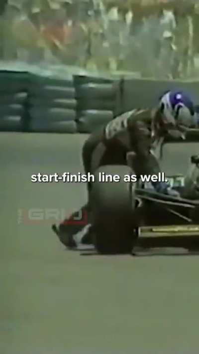 An f1 driver(Nigel Mansell) attempts to push his car over the line after running out of fuel, dallas 1984.
