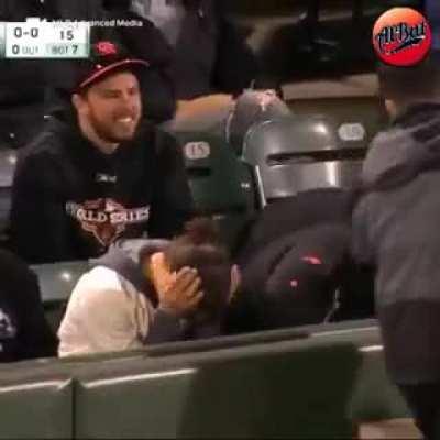 Fan scoops up a ball that's still in play