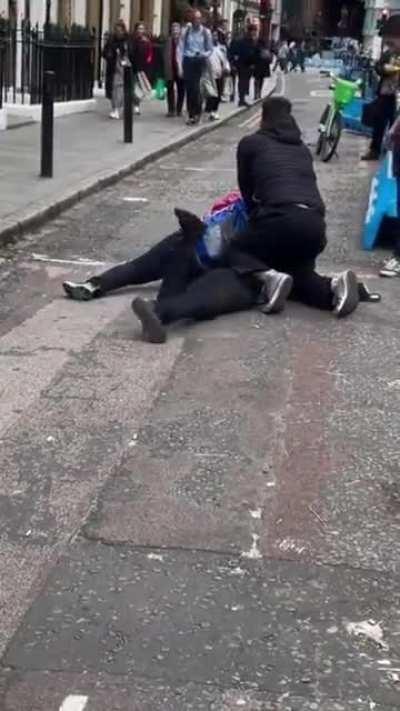 Mobile phone thief tackled to the ground in London.