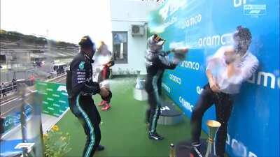 Hamilton and Bottas sprays Bono with champagne at the podium