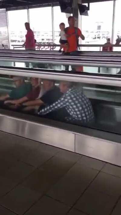Four men having a little fun at an airport.😃