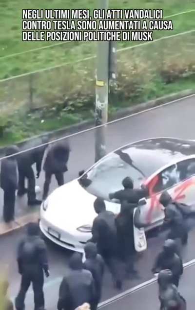A Tesla gets destroyed by a mob in Milan, Italy