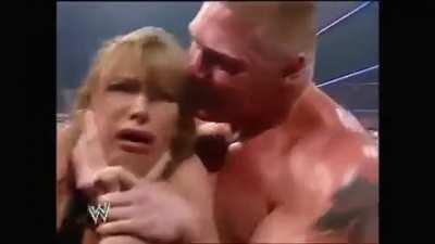 Brock Lesnar throws Stephanie McMahon against the barricade.