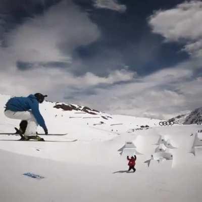 Free-skiier Gian Ragetti skis down the slope backwards, does a flip off the ski jump, high-fives his partner, and lands....backwards.