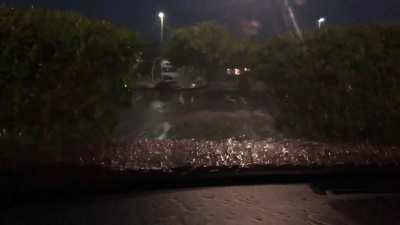 In a parking lot at night