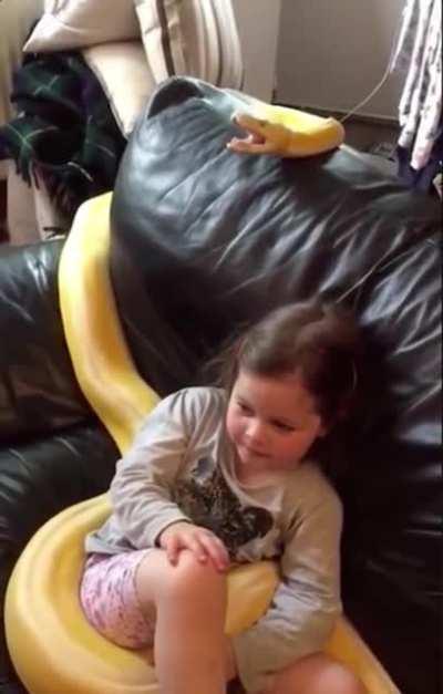 A girl and her snek watching TV