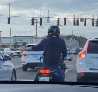A guy having a little party on his bike