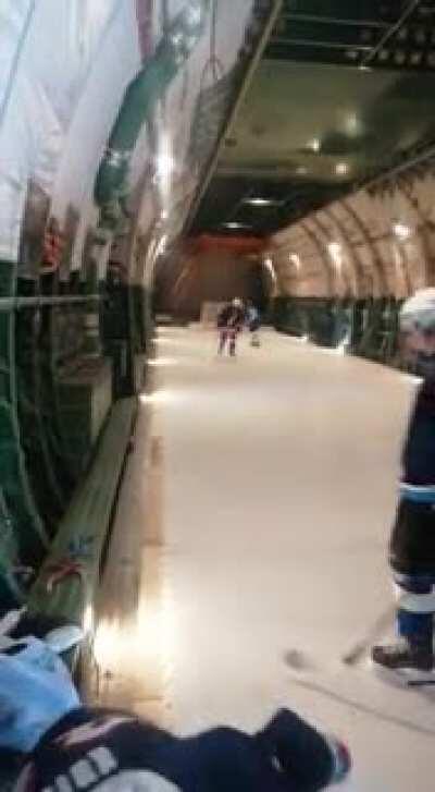 Military personnel play hockey on board the world's largest production cargo aircraft AN-124 