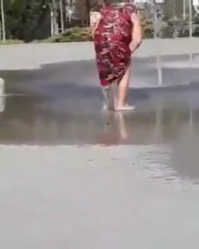 She's washing her stank holes in a children's water fountain