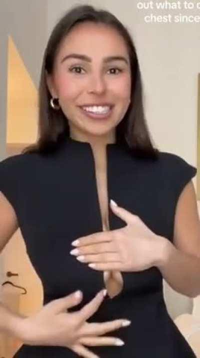 Trying to hide her cleavage 