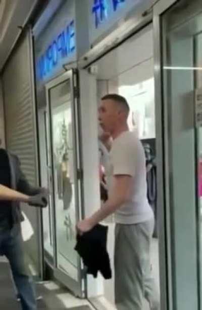 Racist dumbfuck harasses an Asian store. The owner knocks out the racist with one punch.