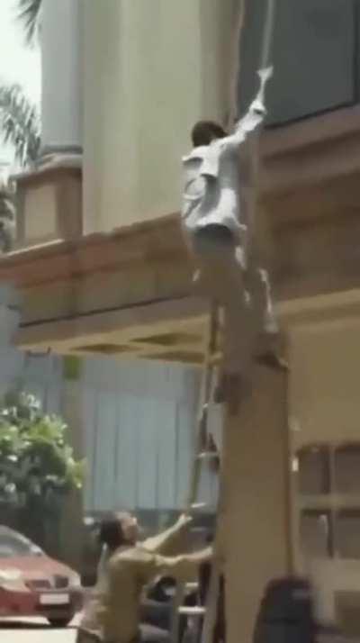 Let me just record this guy doing work on a building