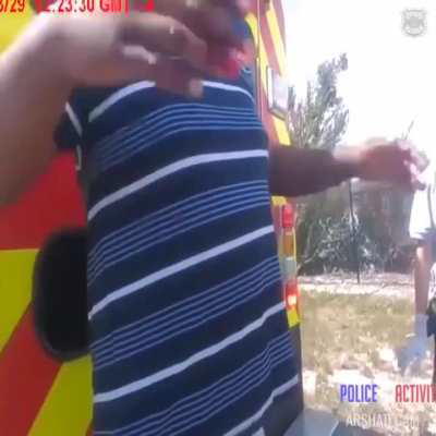 A man who was rescued after crashing his car into a lake grabbed an officer's taser after refusing medical treatment.