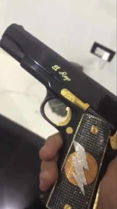 Nini with Mini Lic’s pistol and guitar.