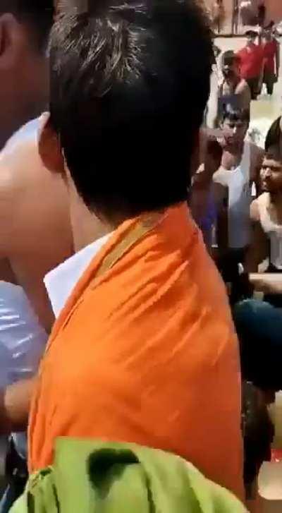 A mob in India beats a husband for kissing his wife during a Hindu mass bathing festival