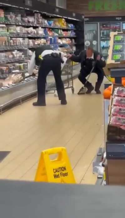 Police officer pulls a coyote out of the produce cooler at a grocery store. WOW.