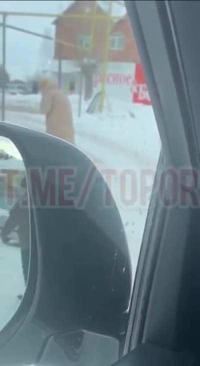 A woman in Kataisk, Russia, catches a pigeon and eats it raw, spitting its feathers into the spring snow