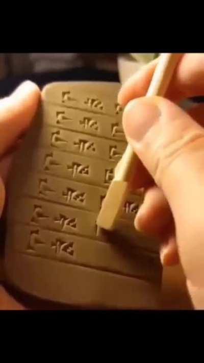 cuneiform writing on clay tablet.