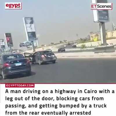 Man blocking highway in Cairo driving with leg out the door gets stopped, beat up and arrested