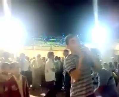 Man hands over a loaded gun to his child at a party.