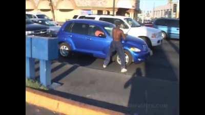 Guy destroys random car with a baseball bat while person is inside