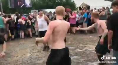 Metalheads teach young girl how to do a mosh pit.