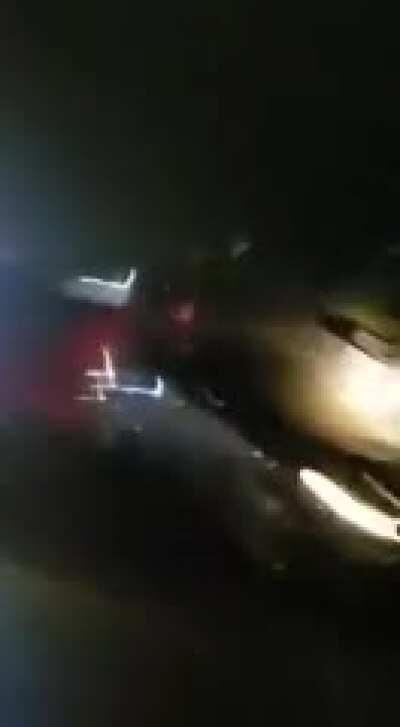 a wheelie on a highway at night