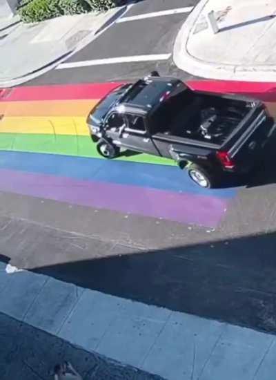 Person leaves tread marks on Pride Flag on Road