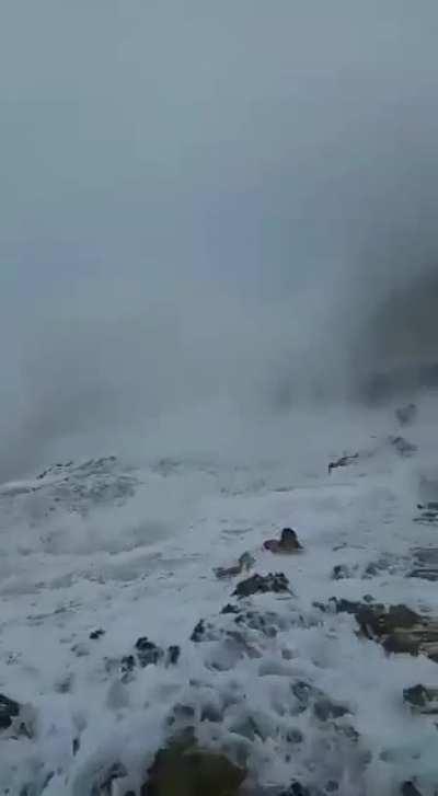 Women standing too close to a beach gets washed away