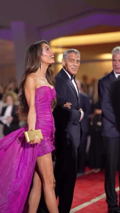 It was drizzling as Amal and George Clooney walked the red carpet at the 2025 Venice Film Festival
