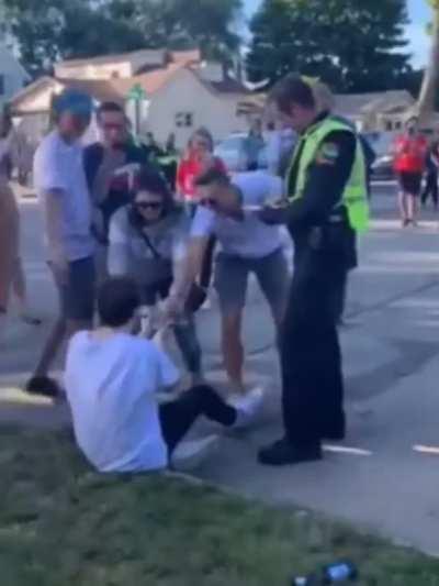 Cop starts giving him a drinking ticket, so everybody starts giving him money to pay it off.