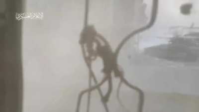 Hamas fighters target an Israeli Namer APC with a tandem-charge RPG