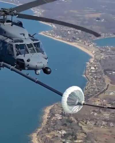 Helicopter refueling in mid air.