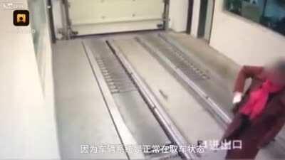 D or V? Woman distracted by cellphone walks into automated underground car park.