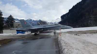 Swiss F/A-18 Hornet crossing a public road to go into it's cavern hangar