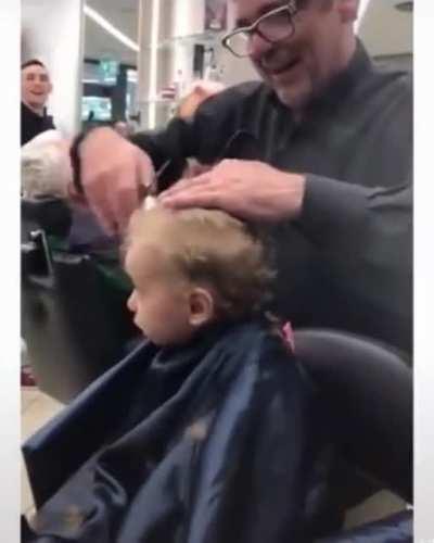 Barbers sing a song to distract a young boy who was not enthusiastic about his haircut
